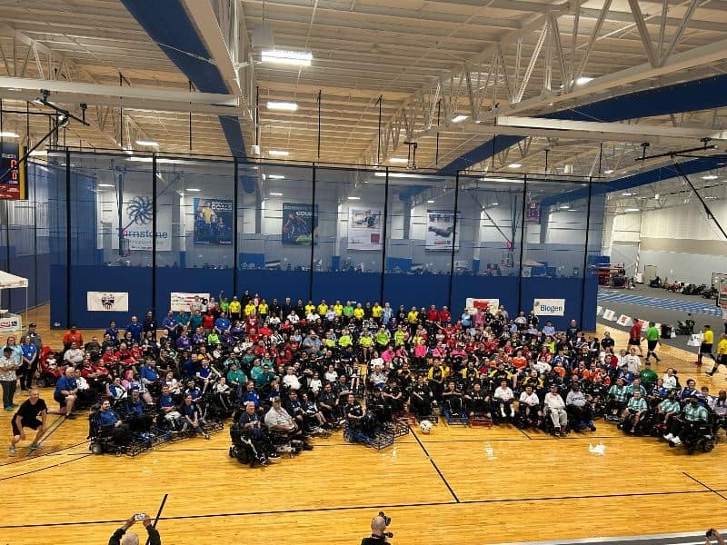 Multiple power soccer teams grouped for a photo at the end of the tournament